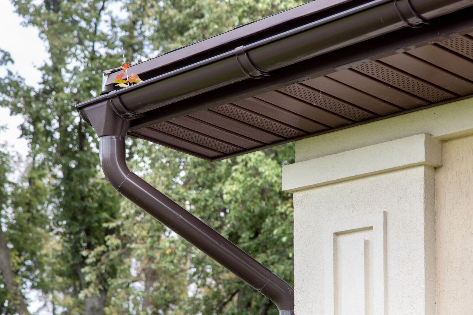 Close up of home with brown gutter system.