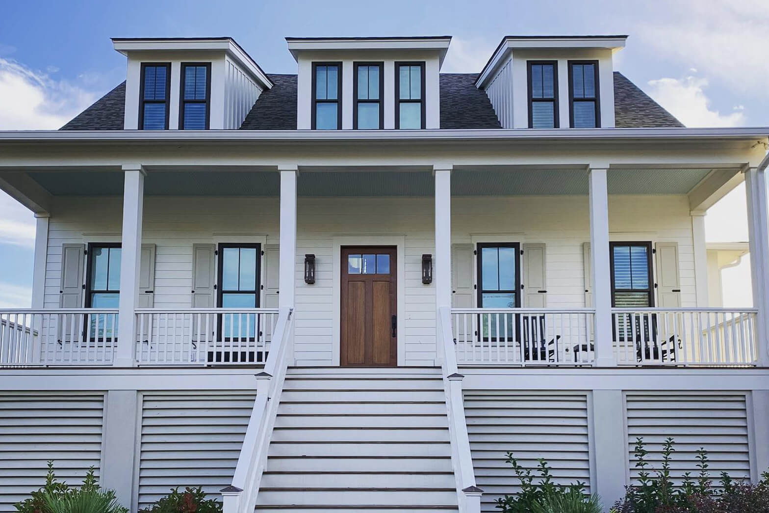 Large white home with white gutter system.
